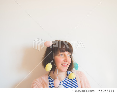 Easter concept female portrait with egg lights Easter concept female portrait with egg lights 63967544