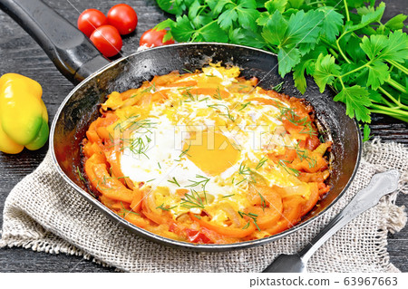 Scrambled eggs with vegetables in pan on board Scrambled eggs with vegetables in pan on board 63967663