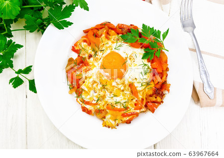 Scrambled eggs with vegetables in plate on board Scrambled eggs with vegetables in plate on board 63967664