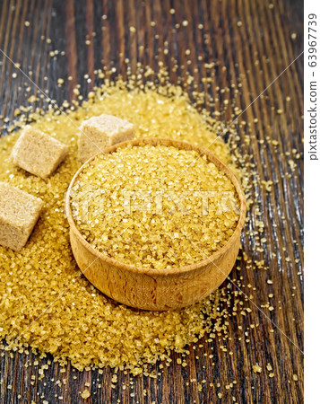 Sugar brown in bowl on board Sugar brown in bowl on board 63967739