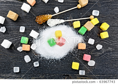 Sugar of different colors and shapes on board top 63967743