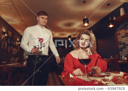 Elegant couple spend time in a restaurant Elegant couple spend time in a restaurant 63967928