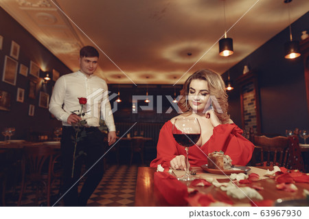 Elegant couple spend time in a restaurant Elegant couple spend time in a restaurant 63967930