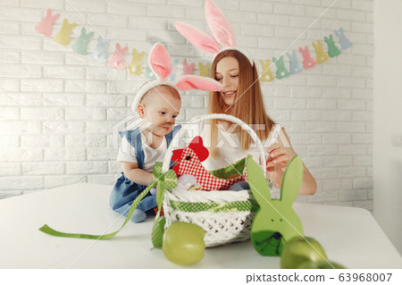 Mother with daughter in a kitchen prepare to easter Mother with daughter in a kitchen prepare to easter 63968007