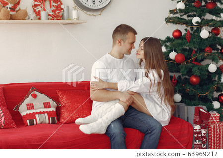 Elegant couple at home near christmas tree 63969212