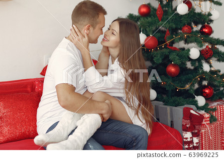 Elegant couple at home near christmas tree 63969225