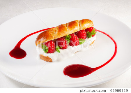 brioche with yogurt and fresh raspberries 63969529