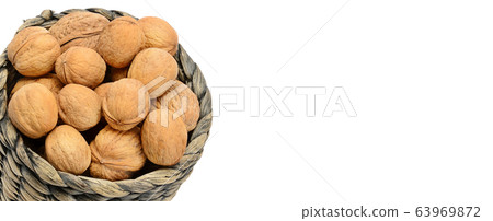 Walnuts in Wicker basket on the white background. Walnuts in Wicker basket on the white background. 63969872