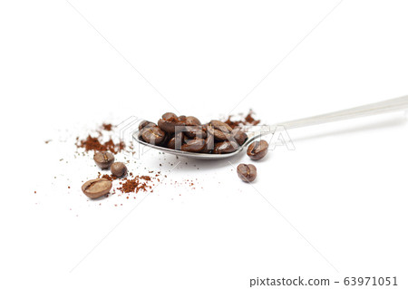 Spoon with coffee beans isolated on white Spoon with coffee beans isolated on white 63971051