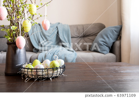 Spring home interior with Easter tree and eggs Spring home interior with Easter tree and eggs 63971109