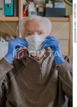 Old man wearing protective mask and gloves Old man wearing protective mask and gloves 63971508