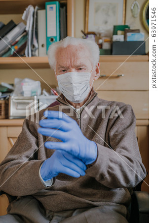 Old man wearing protective mask and gloves Old man wearing protective mask and gloves 63971546