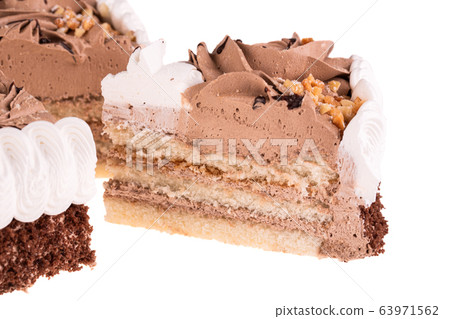 A piece of coffee cake with nuts and cream on a white background A piece of coffee cake with nuts and cream on a white background 63971562
