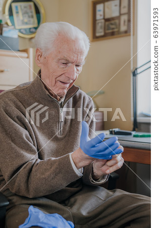 Old man wearing Protective Gloves against Covid-19 Old man wearing Protective Gloves against Covid-19 63971593