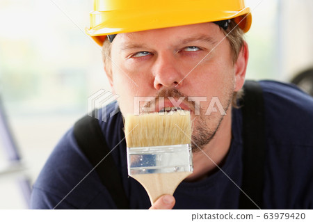 Arm of smiling worker hold brush portrait Arm of smiling worker hold brush portrait 63979420