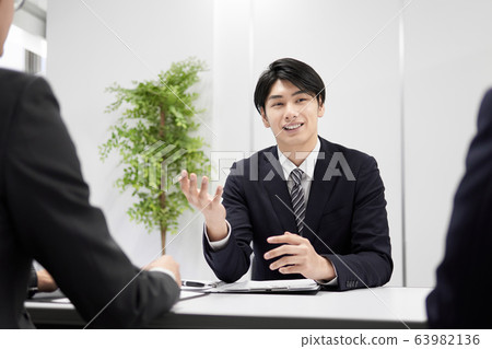 Japanese male businessman explaining in person 63982136
