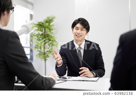 Japanese male businessman explaining in person Japanese male businessman explaining in person 63982138