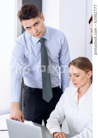 Group of business people using computer in office. Meeting and teamwork concept Group of business people using computer in office. Meeting and teamwork concept 63982777