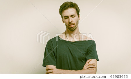 Serious Man In Black T-Shirt Posing With Clasped Hands Serious Man In Black T-Shirt Posing With Clasped Hands 63985653