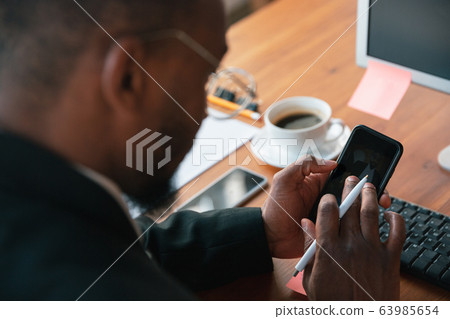 African-american entrepreneur, businessman working concentrated in office 63985654