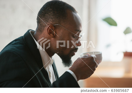 African-american entrepreneur, businessman working concentrated in office African-american entrepreneur, businessman working concentrated in office 63985687