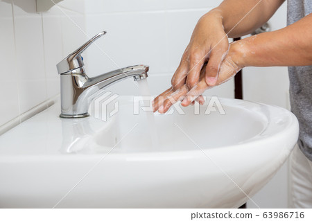 Man Washing hands with for corona virus prevention. Man Washing hands with for corona virus prevention. 63986716