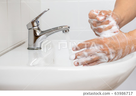 Man Washing hands with for corona virus prevention. Man Washing hands with for corona virus prevention. 63986717