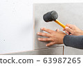 Bricklayer laying tile 63987265