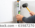 Bricklayer laying tile 63987270