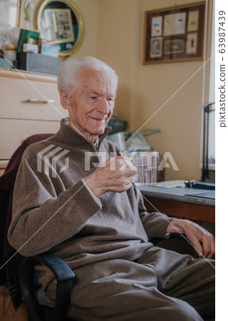 Portrait elderly man drinking water Portrait elderly man drinking water 63987439