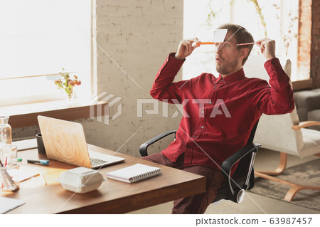 Caucasian entrepreneur, businessman, manager trying to work, looks funny, lazy and spending time 63987457