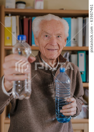 Positive senior holding water bottles Positive senior holding water bottles 63987461
