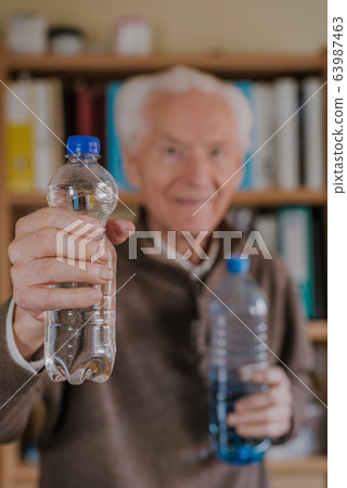 Positive senior holding water bottles Positive senior holding water bottles 63987463