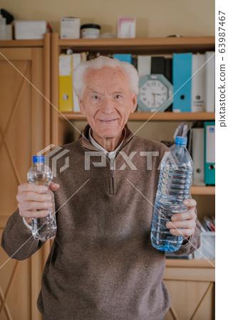 Positive senior holding water bottles Positive senior holding water bottles 63987467