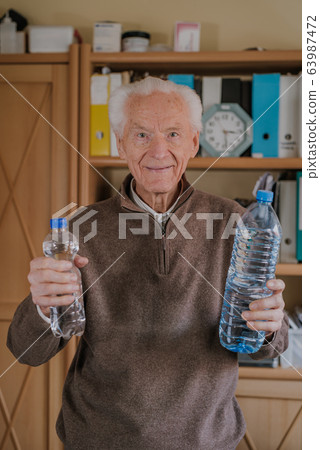 Positive senior holding water bottles Positive senior holding water bottles 63987472