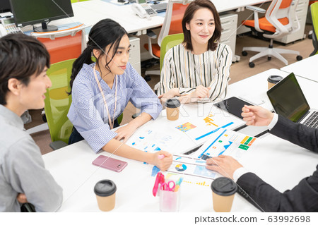 New employee explaining plan to senior in office and boss listening to it New employee explaining plan to senior in office and boss listening to it 63992698