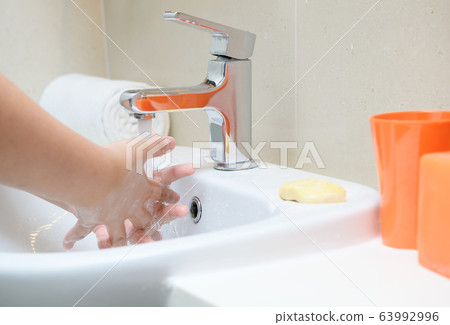 Washing hands child rinsing soap with running Washing hands child rinsing soap with running 63992996
