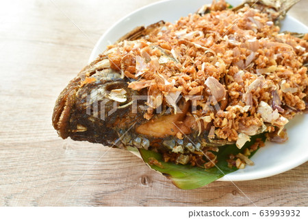 batter fried mango fish topping chop garlic dipping sweet and soy sauce batter fried mango fish topping chop garlic dipping sweet and soy sauce 63993932