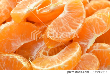 tangerine orange peel out and piece on wooden table 63993933