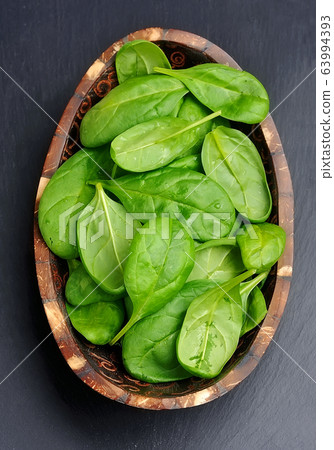 Spinach on black board. Spinach on black board. 63994393