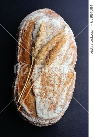 Homemade bread on black board. Homemade bread on black board. 63994394