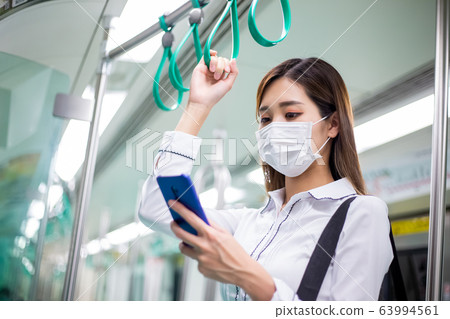 woman with mask in mrt 63994561