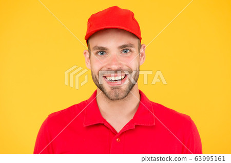 man delivery service in red tshirt and cap. man delivery service in red tshirt and cap. 63995161