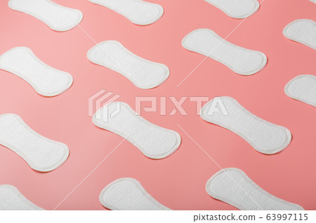 Sanitary pad on a pink background in the form of a 63997115