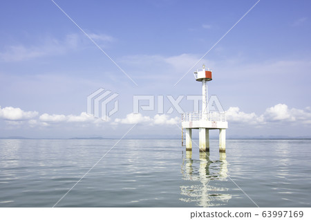 The lighthouse in the sea with eflection of water Background cloud and sky. 63997169