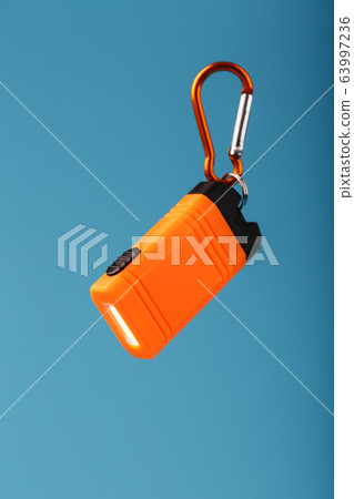 Orange led Flashlight with a carabiner on a blue 63997236