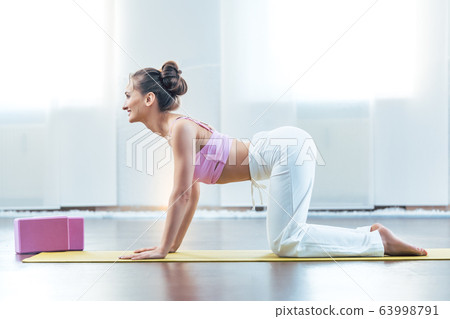 Woman doing the cow yoga pose Woman doing the cow yoga pose 63998791