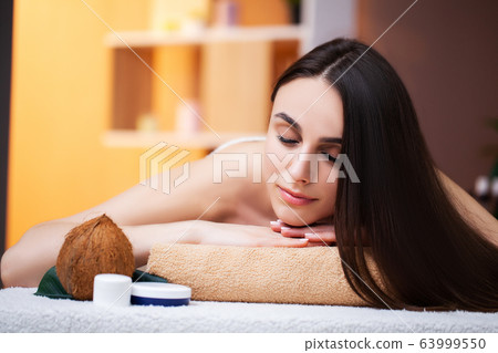 Pretty woman receiving a relaxing massage at the spa salon Pretty woman receiving a relaxing massage at the spa salon 63999550