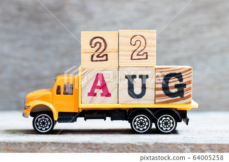 Truck hold letter block in word 22aug on wood background  64005258