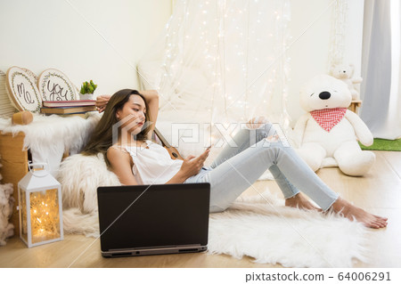 bored woman play smartphone and work from home bored woman play smartphone and work from home 64006291